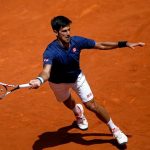 Novak Djokovic returns a ball to Nicolas Almagro during their Madrid Open clash